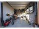 Bright and organized garage space featuring shelving and space to store bikes and other tools at 13236 W Montansoro Ln, Peoria, AZ 85383