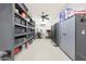 Well-organized garage features ample storage shelves and gray cabinets to maximize space and cleanliness at 13236 W Montansoro Ln, Peoria, AZ 85383