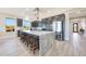 Bright kitchen featuring a large island, stainless steel appliances, and dark wood cabinetry at 13236 W Montansoro Ln, Peoria, AZ 85383