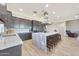 Spacious kitchen with granite countertops, a large island with seating, and stainless steel appliances at 13236 W Montansoro Ln, Peoria, AZ 85383