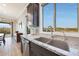 Kitchen sink beneath a large window, stainless steel appliances, and granite countertops at 13236 W Montansoro Ln, Peoria, AZ 85383