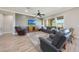 Open living room with large windows, a ceiling fan, and a gray accent wall at 13236 W Montansoro Ln, Peoria, AZ 85383