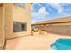 Backyard view showing pool, outdoor grill and counter, and the home's exterior at 13443 W Crocus Dr, Surprise, AZ 85379