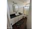 Stylish bathroom features a modern vanity, rectangular mirror, and glass-enclosed shower at 13443 W Crocus Dr, Surprise, AZ 85379