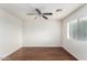 Bright and airy bedroom with natural light, ceiling fan, and hardwood floors at 13443 W Crocus Dr, Surprise, AZ 85379