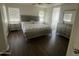 Serene bedroom features a luxurious bed, matching nightstands, and plenty of natural light at 13443 W Crocus Dr, Surprise, AZ 85379