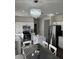 Modern kitchen features white cabinets, stainless steel appliances, and a stunning chandelier at 13443 W Crocus Dr, Surprise, AZ 85379