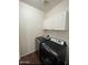 Convenient laundry room with modern washer and dryer, plus overhead storage cabinets at 13443 W Crocus Dr, Surprise, AZ 85379