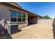 Private backyard features desert landscaping, covered patio, and block wall for added privacy at 14045 W Desert Flower Dr, Goodyear, AZ 85395