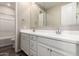 Bathroom featuring a double sink vanity with white cabinetry and modern fixtures at 14045 W Desert Flower Dr, Goodyear, AZ 85395