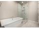 Luxurious bathroom features a soaking tub and a separate glass-enclosed shower at 14045 W Desert Flower Dr, Goodyear, AZ 85395