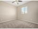 Cozy bedroom showcasing a ceiling fan and a bright window allowing for natural light at 14045 W Desert Flower Dr, Goodyear, AZ 85395