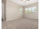 Spacious bedroom with plush carpet, fan and large windows for natural light at 14045 W Desert Flower Dr, Goodyear, AZ 85395