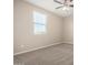Bright bedroom featuring a ceiling fan and large window, perfect for relaxation at 14045 W Desert Flower Dr, Goodyear, AZ 85395