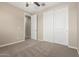 Neutral bedroom with a ceiling fan and closet doors, providing storage and comfort at 14045 W Desert Flower Dr, Goodyear, AZ 85395