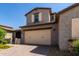 Attractive two-story home with a brick driveway, two-car garage, and beautifully landscaped yard at 14045 W Desert Flower Dr, Goodyear, AZ 85395