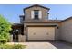 Charming two-story home boasts a brick driveway, two-car garage, and landscaped front yard at 14045 W Desert Flower Dr, Goodyear, AZ 85395