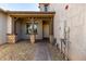Inviting home entrance with stone accents, covered porch, brick paver pathway, neutral paint, and well-maintained landscaping at 14045 W Desert Flower Dr, Goodyear, AZ 85395