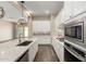 Bright kitchen features white cabinetry, stainless appliances, and center island at 14045 W Desert Flower Dr, Goodyear, AZ 85395