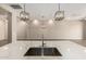 Modern kitchen with quartz countertops, stainless steel sink, and pendant lighting at 14045 W Desert Flower Dr, Goodyear, AZ 85395