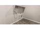 Clean laundry area featuring hookups and built-in shelving for organized storage at 14045 W Desert Flower Dr, Goodyear, AZ 85395