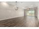 Expansive living area featuring durable tile flooring, neutral colored walls, a sliding door to the backyard, and ample natural light at 14045 W Desert Flower Dr, Goodyear, AZ 85395