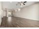 Spacious living room with tile flooring, neutral walls, recessed lighting, ceiling fan, and open access to the adjacent room at 14045 W Desert Flower Dr, Goodyear, AZ 85395