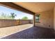 Relaxing covered patio with brick pavers, block walls, desert landscaping, and an open view at 14045 W Desert Flower Dr, Goodyear, AZ 85395