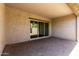 Covered patio features brick pavers, textured walls, recessed lighting, and sliding glass doors at 14045 W Desert Flower Dr, Goodyear, AZ 85395