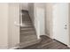 Staircase with neutral carpet, white railing, and tile flooring at the base, leading to the upper level at 14045 W Desert Flower Dr, Goodyear, AZ 85395