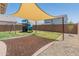 Spacious backyard featuring a play structure, patio, and shade, great for outdoor entertainment at 14435 W El Cortez Pl, Surprise, AZ 85387