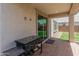 Covered patio with a built-in grill, overlooking a well-maintained backyard at 14435 W El Cortez Pl, Surprise, AZ 85387