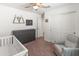 Bedroom room with a crib, dresser, and mountain decor at 14435 W El Cortez Pl, Surprise, AZ 85387