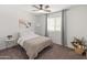 Neutral bedroom with natural light, a bed, and simple decor at 14435 W El Cortez Pl, Surprise, AZ 85387