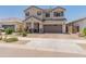 Charming two-story home with a well-maintained front yard and a two-car garage at 14435 W El Cortez Pl, Surprise, AZ 85387