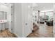 Hallway featuring a powder room, staircase, and views into the living space at 14435 W El Cortez Pl, Surprise, AZ 85387