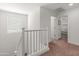 Second floor hallway with natural light and white railing at 14435 W El Cortez Pl, Surprise, AZ 85387