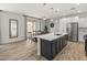 Bright kitchen with a large island, stainless steel appliances, and an adjacent dining area at 14435 W El Cortez Pl, Surprise, AZ 85387