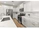Stylish kitchen with stainless steel appliances, white cabinets, and a modern island at 14435 W El Cortez Pl, Surprise, AZ 85387