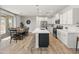 Modern kitchen with white cabinets, stainless steel appliances, and a large island at 14435 W El Cortez Pl, Surprise, AZ 85387
