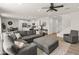 Bright and open-concept living room with stairs, modern furnishings, and wood-look floors at 14435 W El Cortez Pl, Surprise, AZ 85387