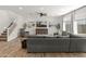 Comfortable living room featuring a plush sectional sofa, accent chairs, and a staircase leading to the upper level at 14435 W El Cortez Pl, Surprise, AZ 85387