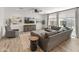 Bright living room with comfortable gray sectional sofa, modern decor, and lots of natural light at 14435 W El Cortez Pl, Surprise, AZ 85387
