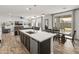 Open-concept living space with a large kitchen island, dining area, and seamless access to the outdoors at 14435 W El Cortez Pl, Surprise, AZ 85387