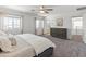 Spacious main bedroom with carpeting, windows and entry to bathroom at 14435 W El Cortez Pl, Surprise, AZ 85387