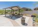 Covered picnic area with tables and grill, perfect for outdoor gatherings and enjoying the community amenities at 14435 W El Cortez Pl, Surprise, AZ 85387