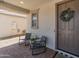 Inviting front porch with seating and a decorative wreath on the front door at 14435 W El Cortez Pl, Surprise, AZ 85387
