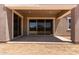 Covered back patio featuring recessed lights, a large sliding glass door, and ample space for outdoor living at 15833 W Bronco Trl, Surprise, AZ 85387