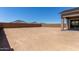 Large, flat backyard ready for landscaping, outdoor activities, and potential pool or garden area at 15833 W Bronco Trl, Surprise, AZ 85387
