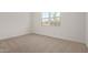 Bedroom boasts bright windows, neutral carpet and a view of an exterior home at 15833 W Bronco Trl, Surprise, AZ 85387